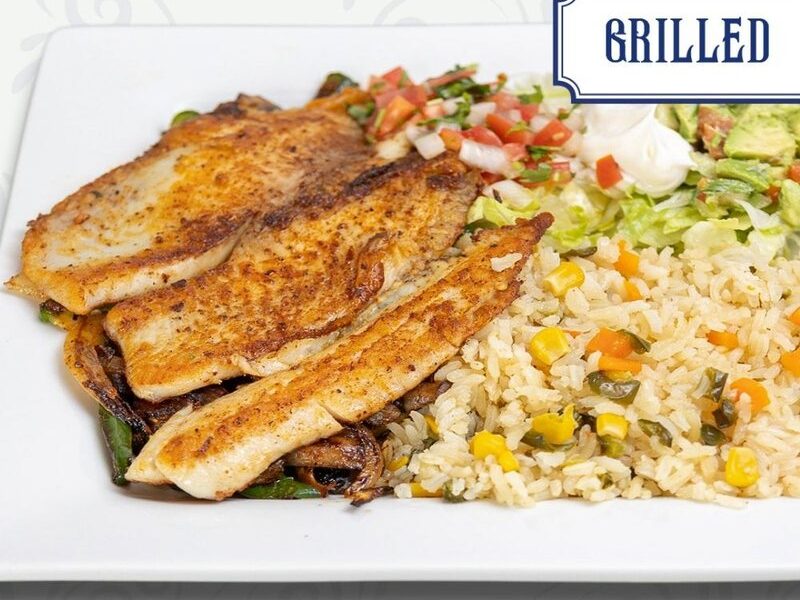 Grilled fish fillets over peppers and onions with Mexican rice, pico de gallo and guacamole