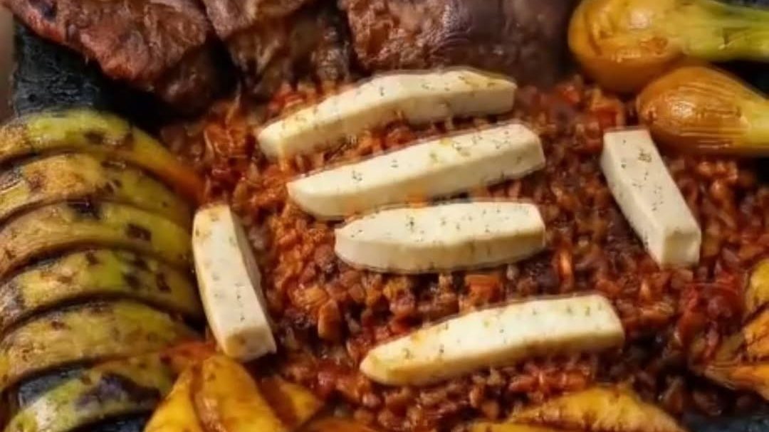 A Mamalon Molcajete with grilled meats, plantains and panela cheese at Las Mamalonas in Little Rock